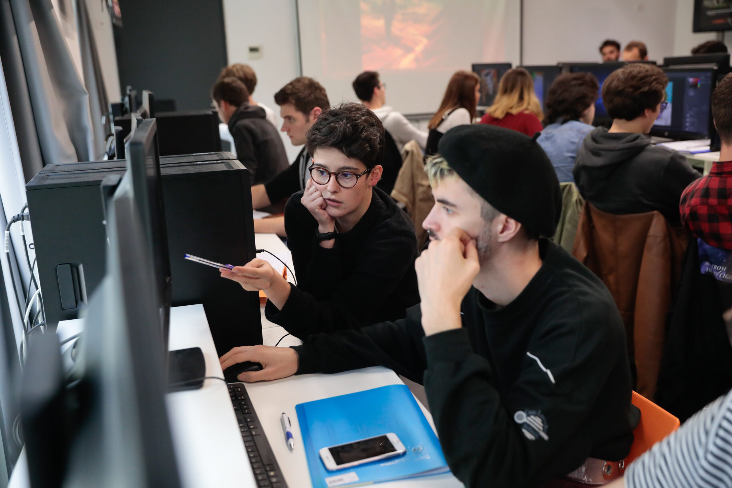 ESMA students working together on computers in the computer room