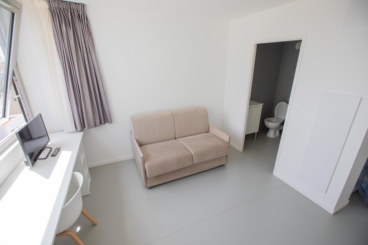 Student studio in the Artemisia Rennes residence with sofa and office space
