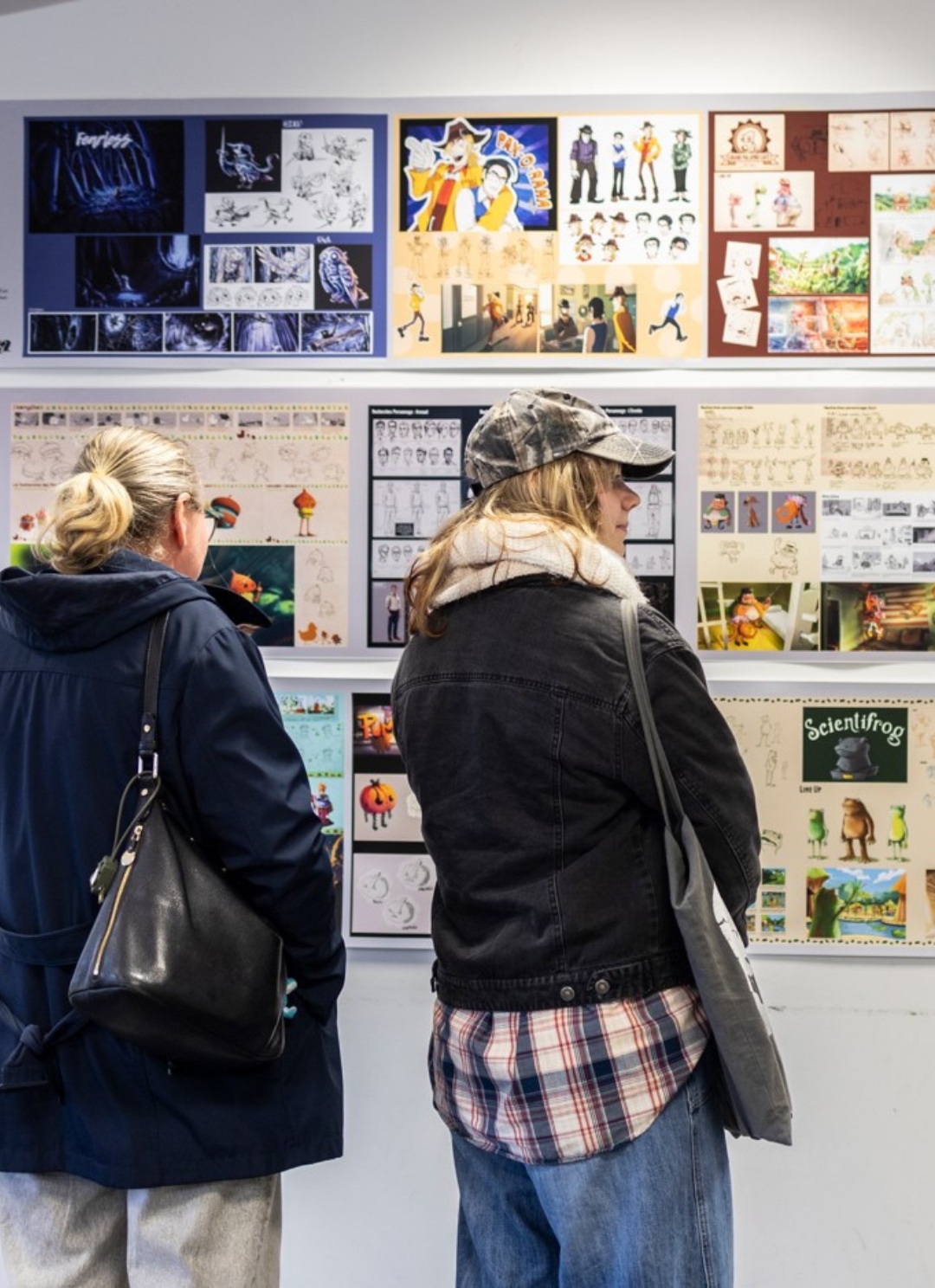 Visitors looking at character design and storyboard boards produced by ESMA students