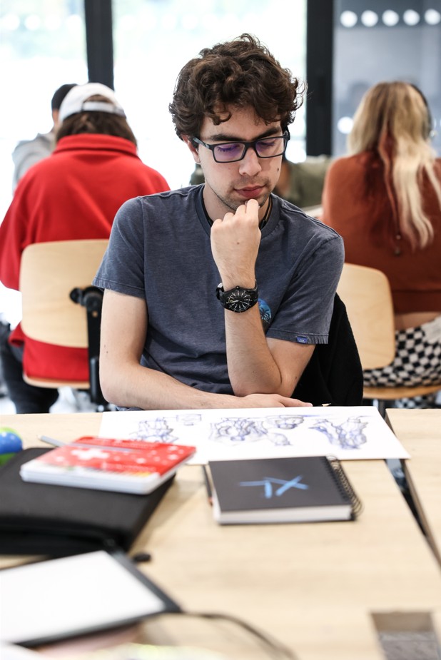 Student concentrating on a drawing in class at ESMA.