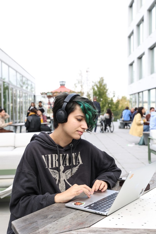 ESMA 3D Nantes student working on a laptop outside on campus